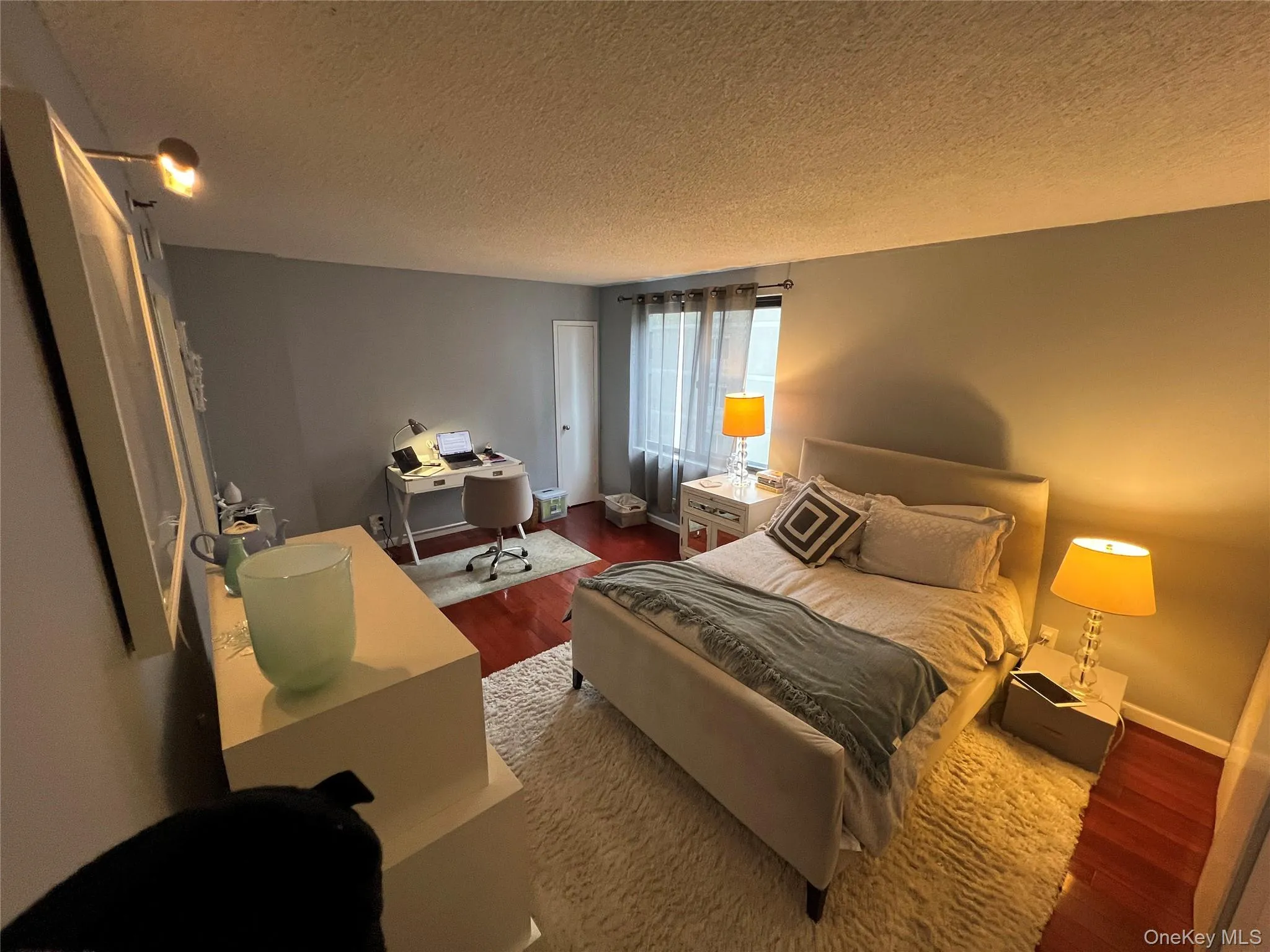 Bedroom with baseboards, and wood finished floors Bedroom with baseboards, and wood finished floors