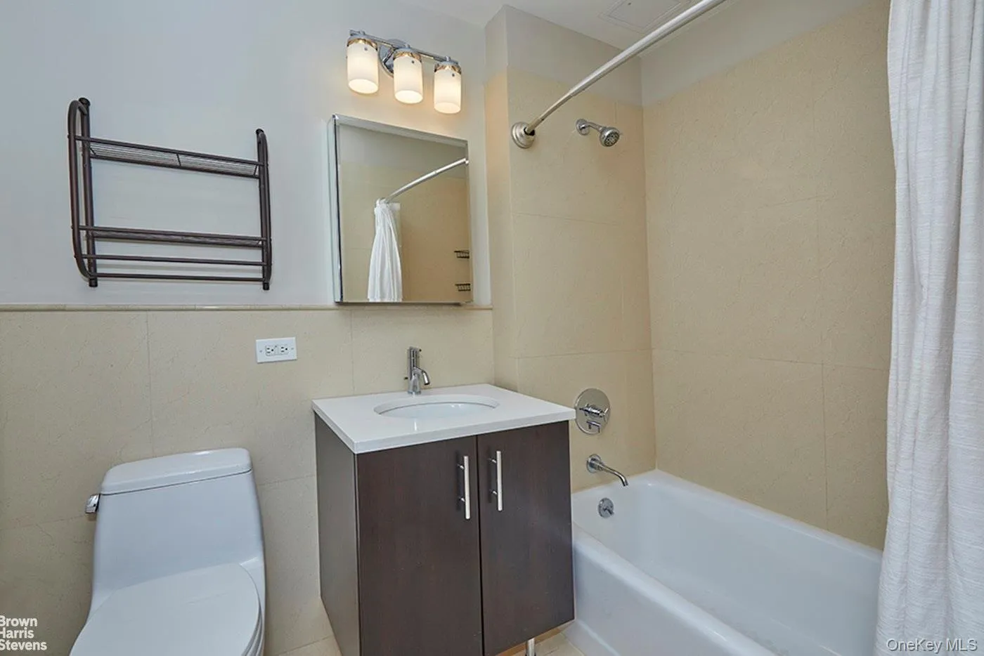 Full bathroom featuring shower / tub combo and vanity Full bathroom featuring shower / tub combo and vanity