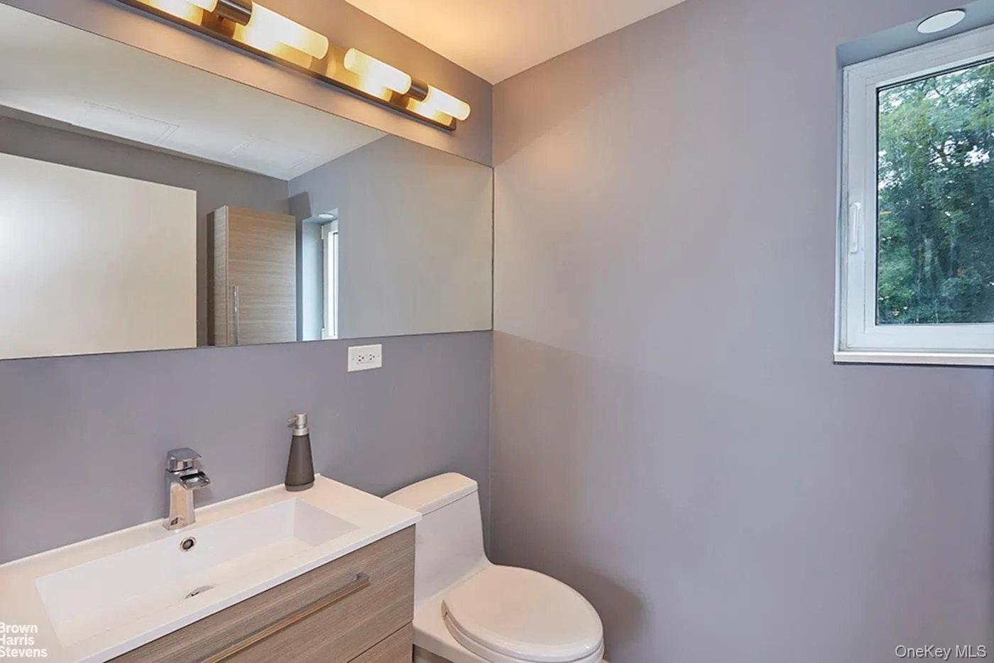Bathroom with toilet and vanity Bathroom with toilet and vanity