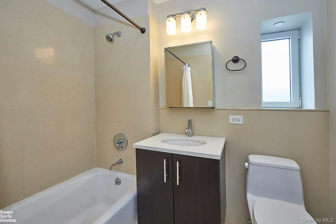 Full bathroom featuring shower / bathtub combination with curtain and vanity Full bathroom featuring shower / bathtub combination with curtain and vanity
