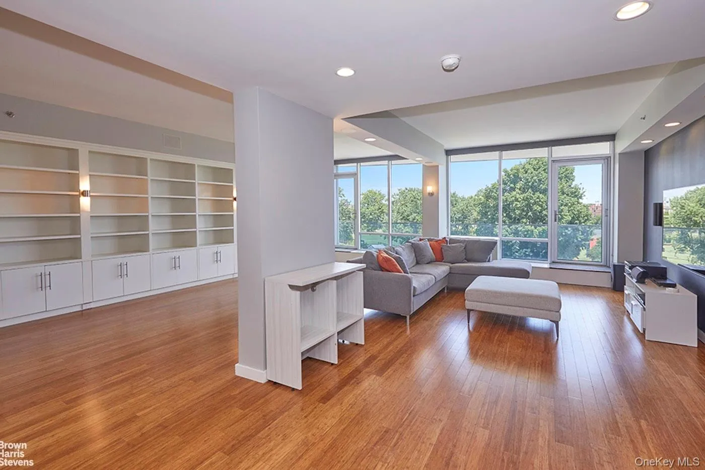 Living room featuring wood finished floors and recessed lighting Living room featuring wood finished floors and recessed lighting