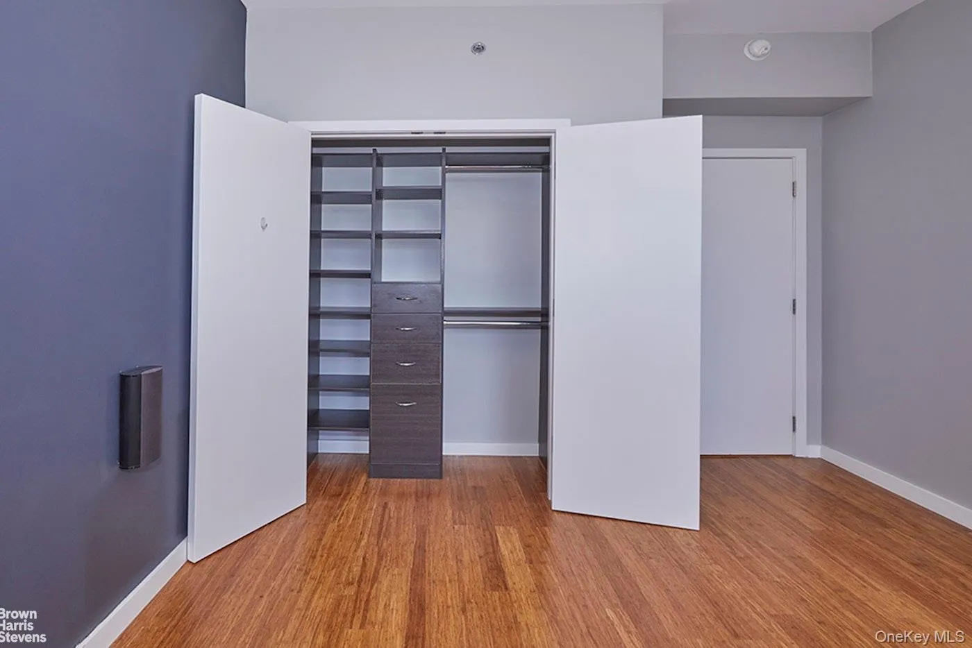 Unfurnished bedroom with light wood finished floors and a closet Unfurnished bedroom with light wood finished floors and a closet