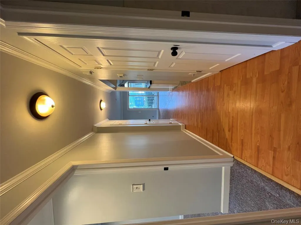 Hall featuring crown molding and light wood-style flooring Hall featuring crown molding and light wood-style flooring