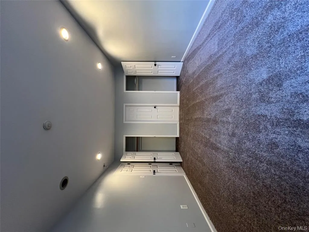 Unfurnished bedroom featuring two closets, dark colored carpet, and recessed lighting Unfurnished bedroom featuring two closets, dark colored carpet, and recessed lighting