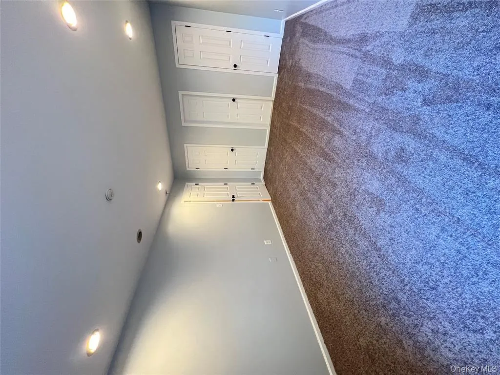 Empty room featuring recessed lighting and carpet flooring Empty room featuring recessed lighting and carpet flooring