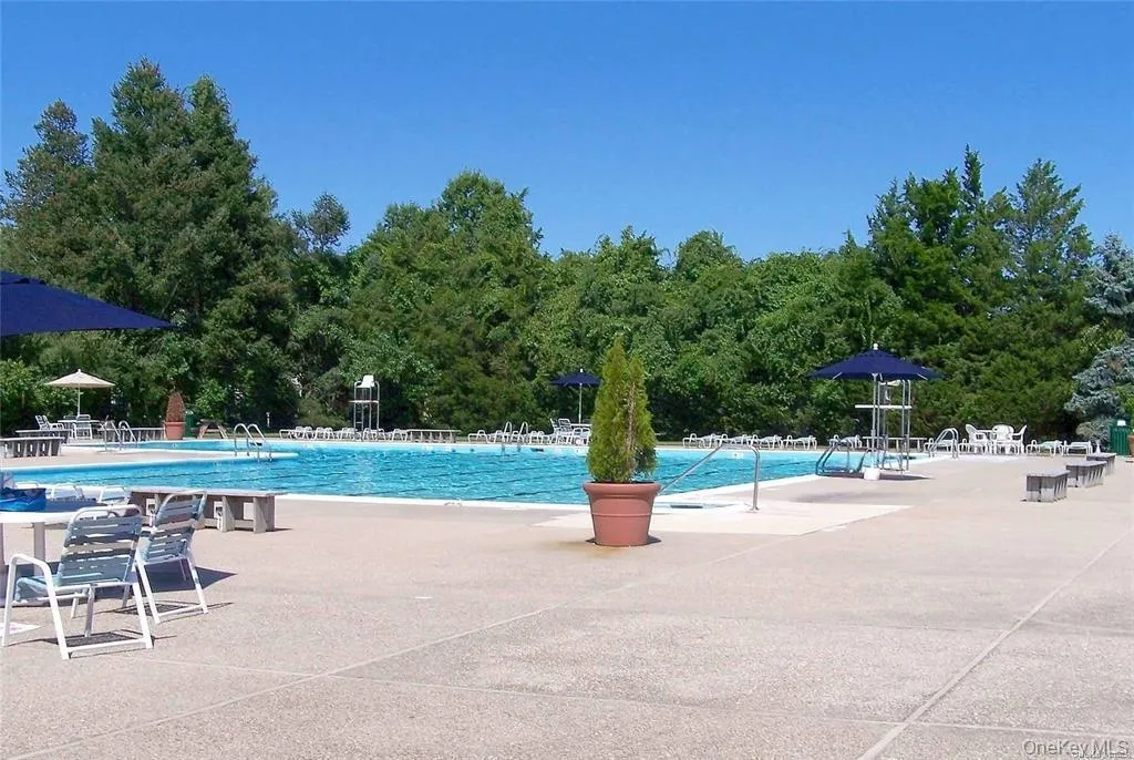 Community pool featuring a patio area Community pool featuring a patio area