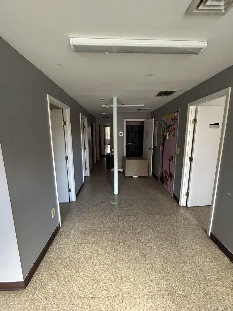Corridor with baseboards and light floors Corridor with baseboards and light floors