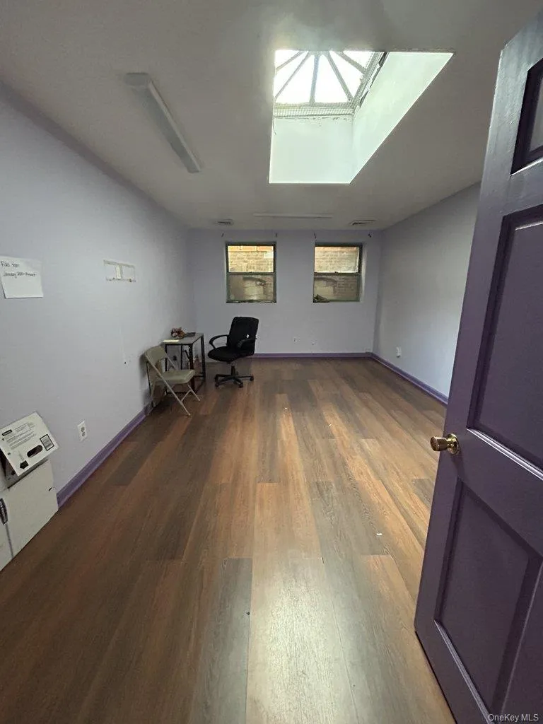 Unfurnished office with dark wood-style flooring Unfurnished office with dark wood-style flooring