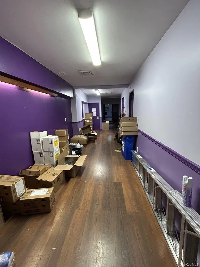 Corridor featuring dark wood-style floors Corridor featuring dark wood-style floors