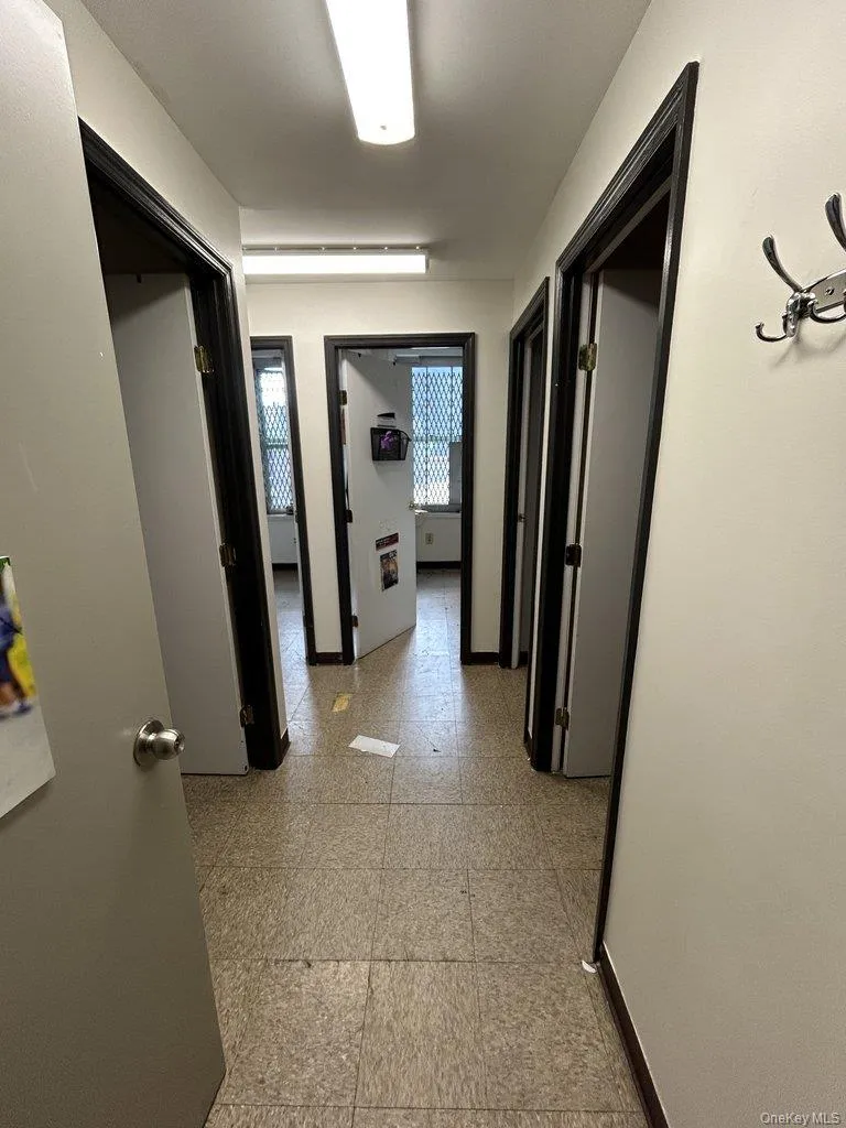 Hall with baseboards and light floors Hall with baseboards and light floors