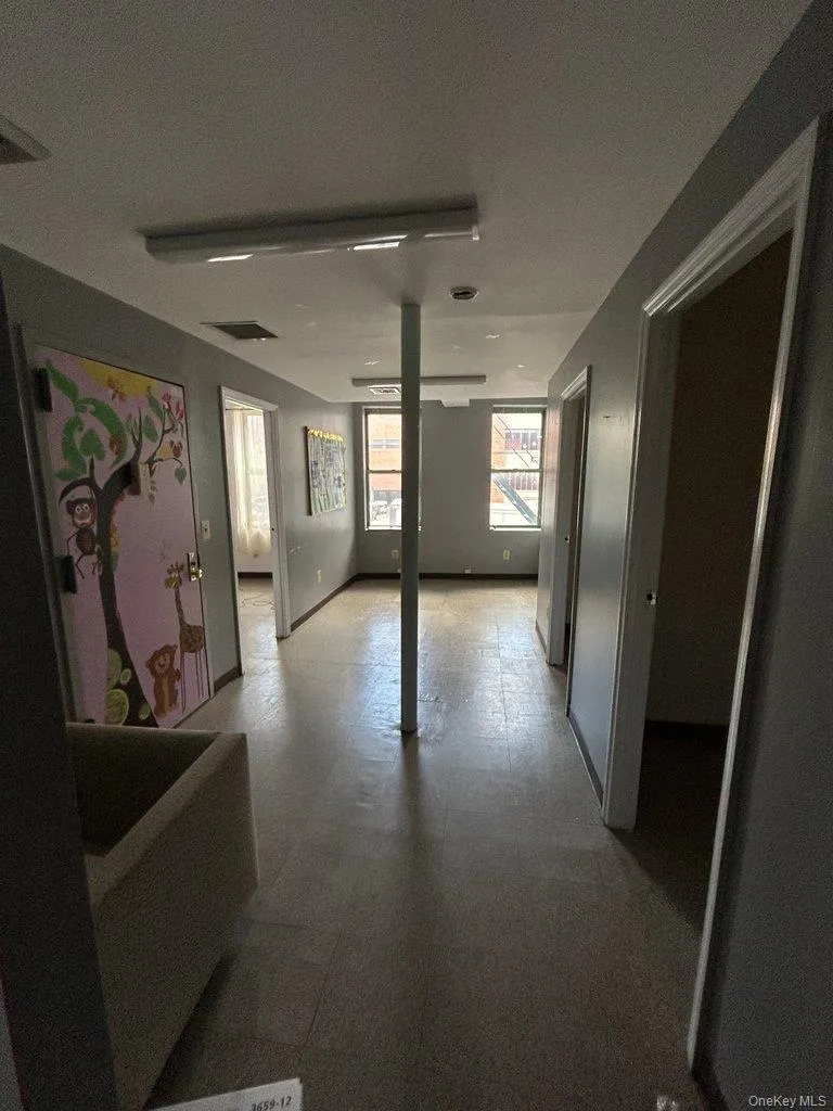 Hallway with light flooring and baseboards Hallway with light flooring and baseboards