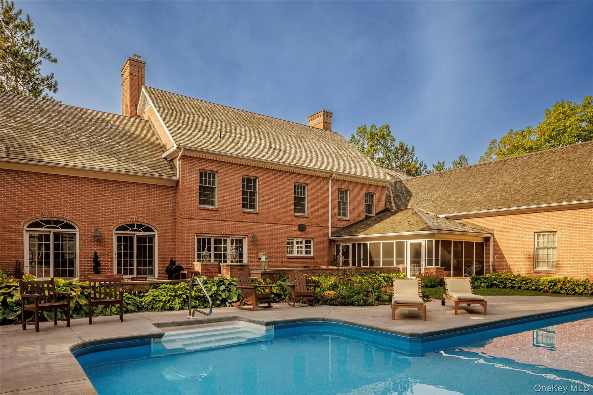 Swimming pool with a sunroom and a patio area Swimming pool with a sunroom and a patio area