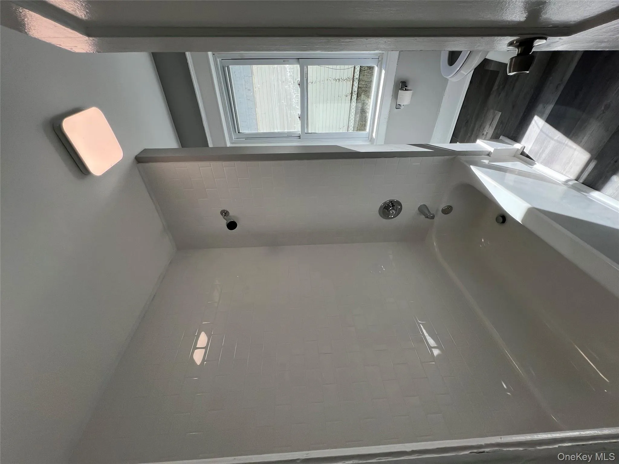 Bathroom featuring shower / bathtub combination and dark wood finished floors Bathroom featuring shower / bathtub combination and dark wood finished floors