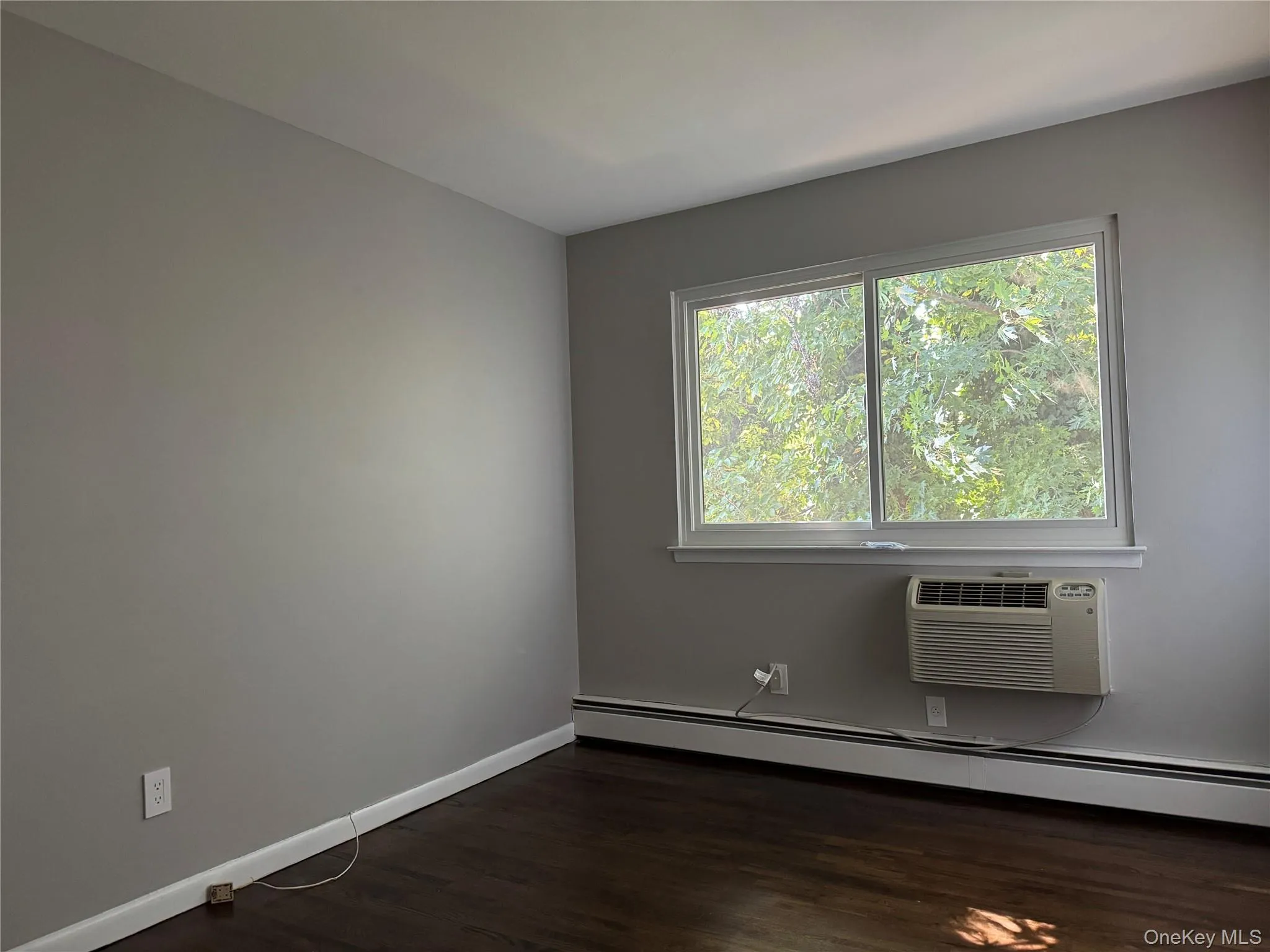 Bedroom with dark wood finished floors. Bedroom with dark wood finished floors.