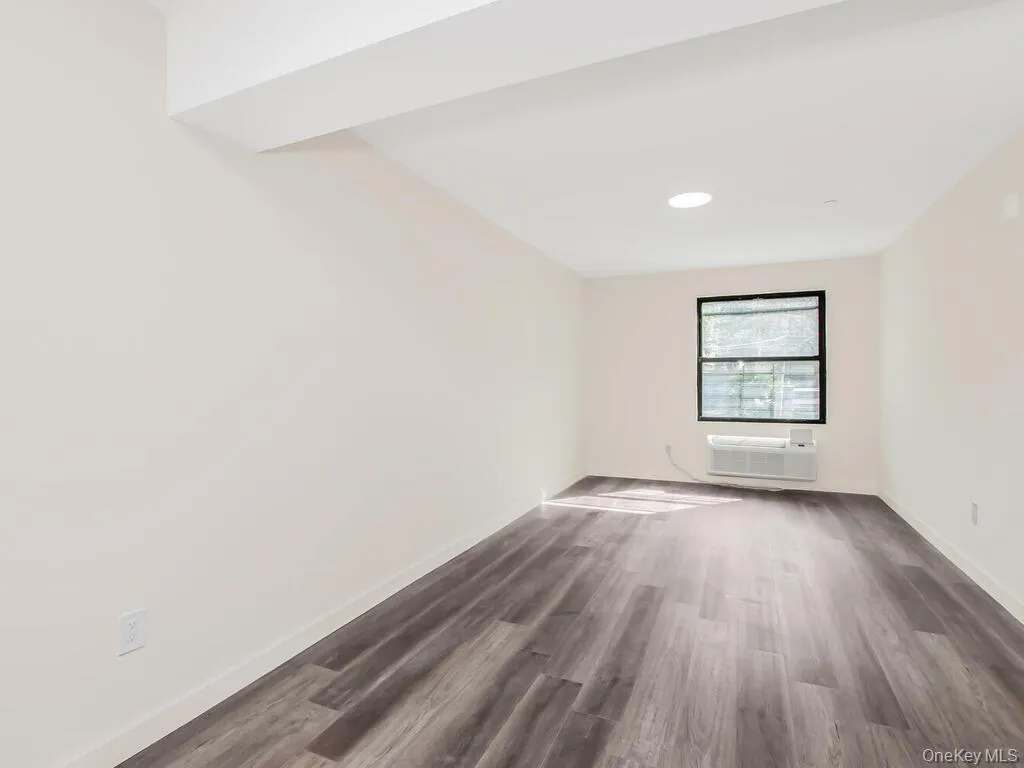 Spare room with dark wood-style floors and recessed lighting Spare room with dark wood-style floors and recessed lighting