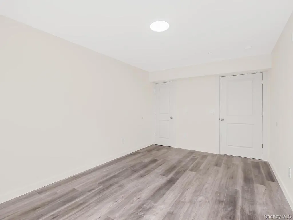 Unfurnished bedroom with a closet and wood finished floors Unfurnished bedroom with a closet and wood finished floors