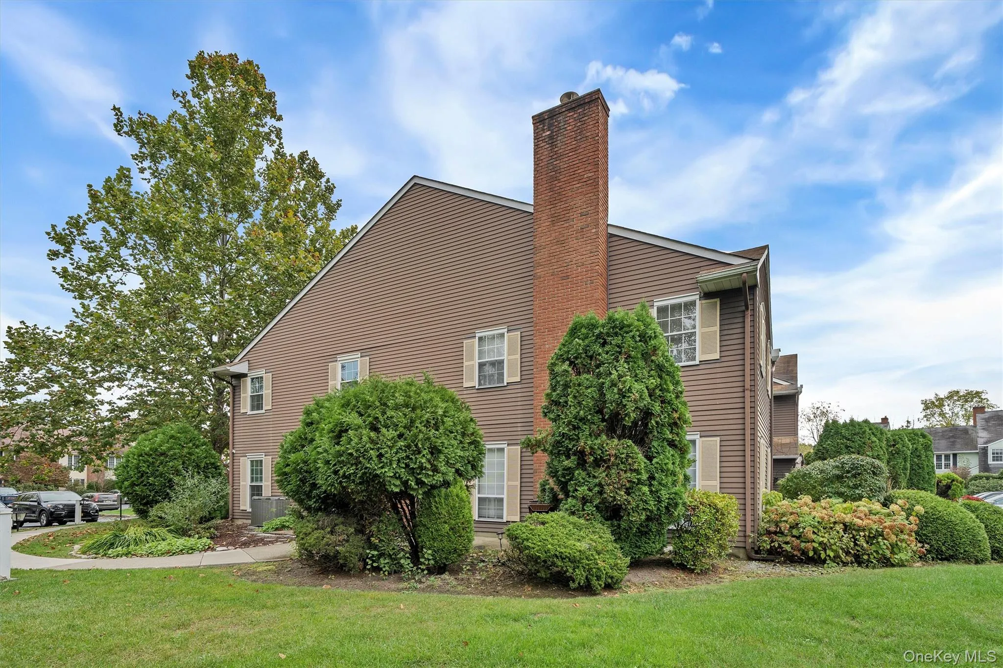 View of home's exterior featuring a yard and a chimney View of home's exterior featuring a yard and a chimney