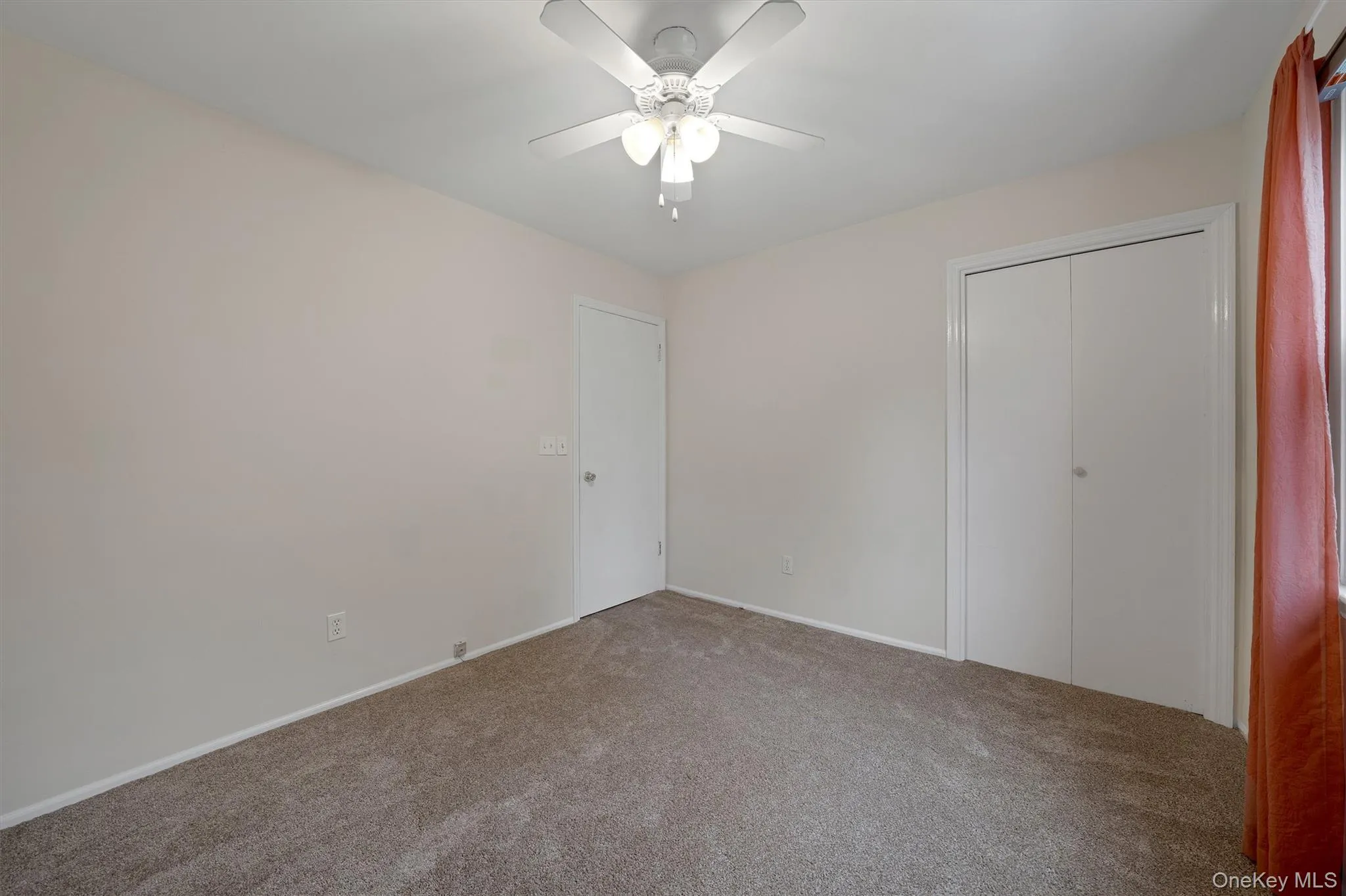 Unfurnished bedroom featuring carpet floors, ceiling fan, and a closet Unfurnished bedroom featuring carpet floors, ceiling fan, and a closet