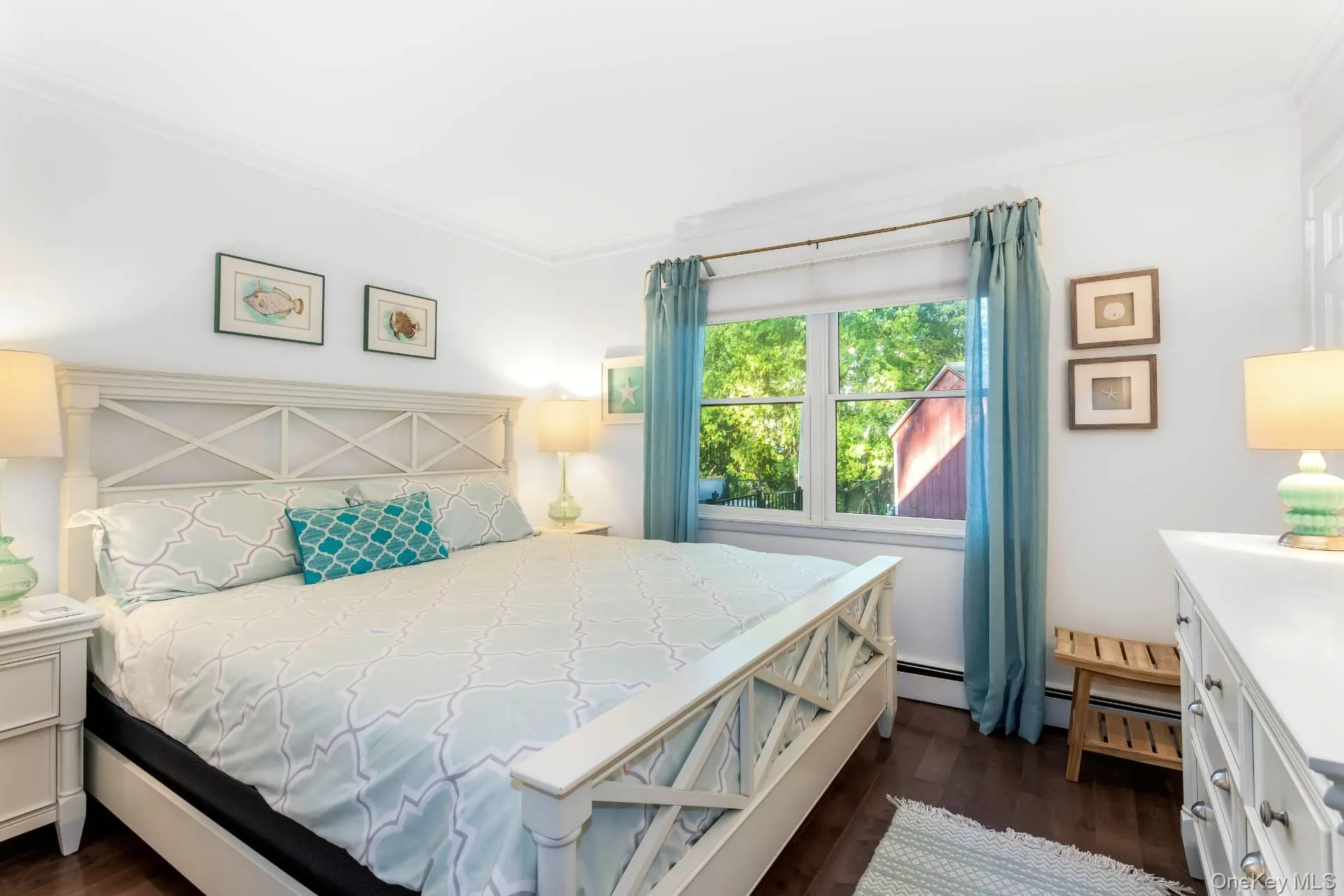 Bedroom featuring dark wood-type flooring and ornamental molding Bedroom featuring dark wood-type flooring and ornamental molding