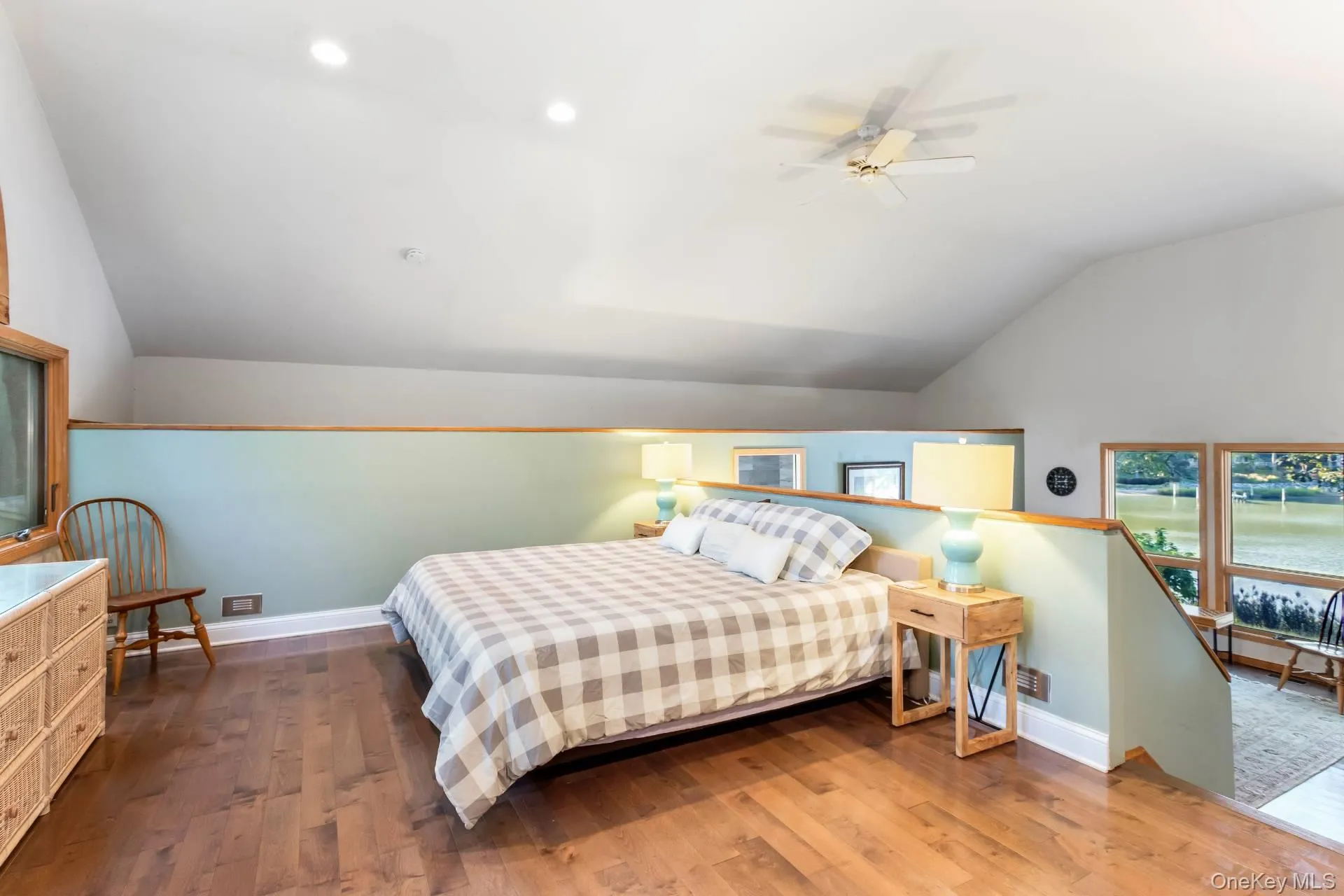 Bedroom with vaulted ceiling, dark wood finished floors, a ceiling fan, and recessed lighting Bedroom with vaulted ceiling, dark wood finished floors, a ceiling fan, and recessed lighting
