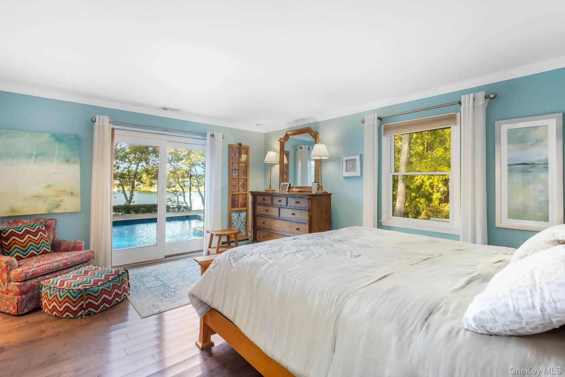 Bedroom featuring access to exterior, wood finished floors, and ornamental molding Bedroom featuring access to exterior, wood finished floors, and ornamental molding