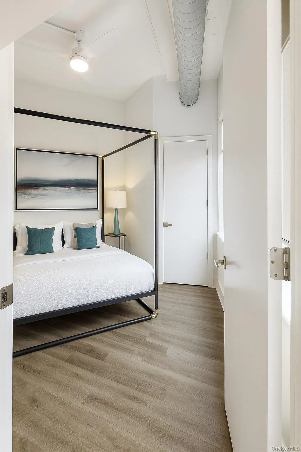Bedroom with light wood-style floors and ceiling fan Bedroom with light wood-style floors and ceiling fan
