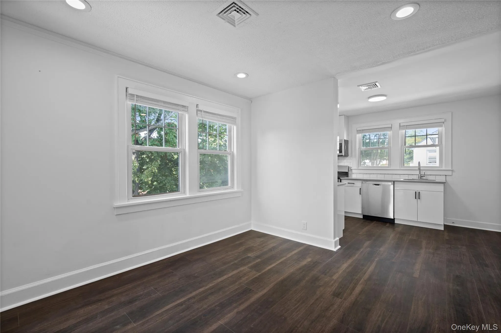 Unfurnished dining area with recessed lighting and dark wood-style floors Unfurnished dining area with recessed lighting and dark wood-style floors