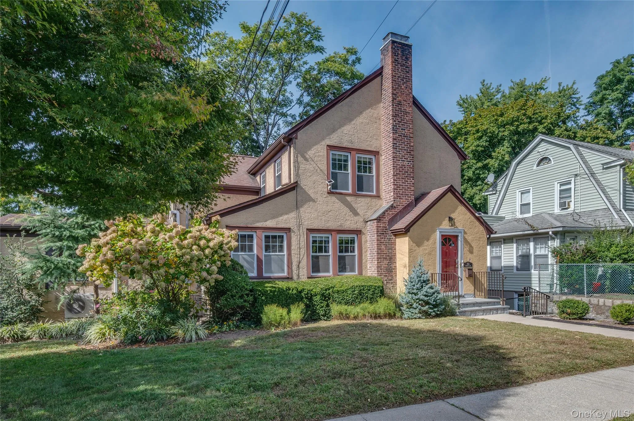 View of front of property with stucco siding and a chimney View of front of property with stucco siding and a chimney