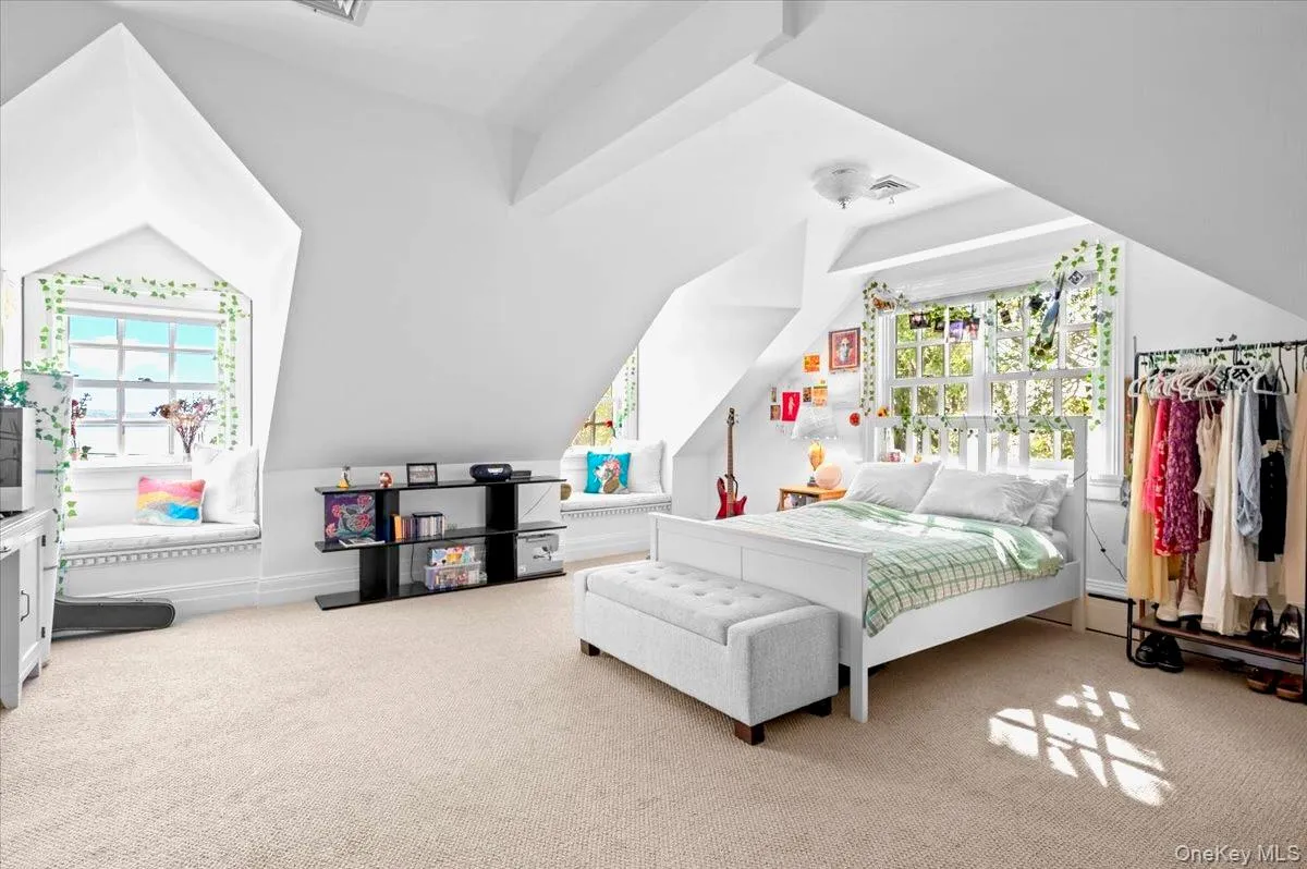 Bedroom with light colored carpet and lofted ceiling Bedroom with light colored carpet and lofted ceiling