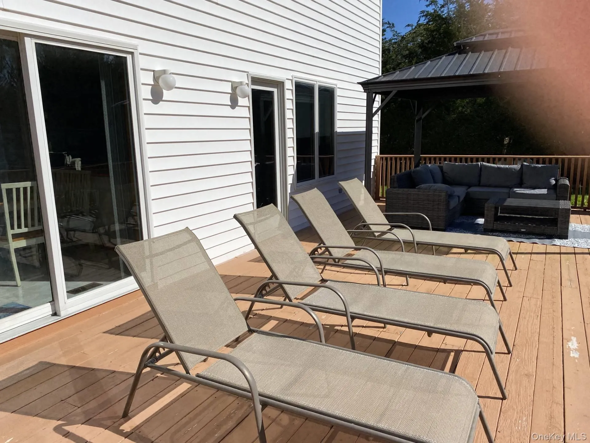 Wooden deck featuring an outdoor living space and a gazebo Wooden deck featuring an outdoor living space and a gazebo