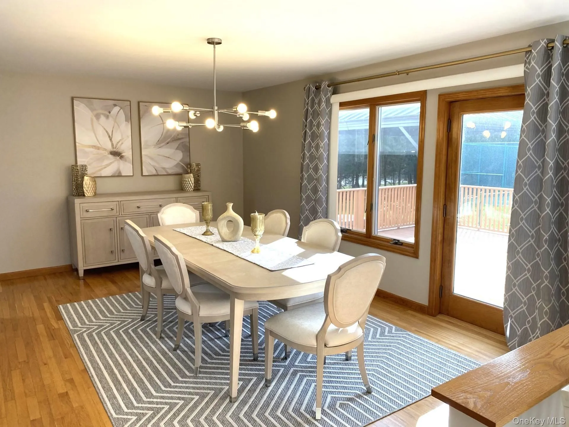 Dining room with light wood finished floors and a chandelier Dining room with light wood finished floors and a chandelier