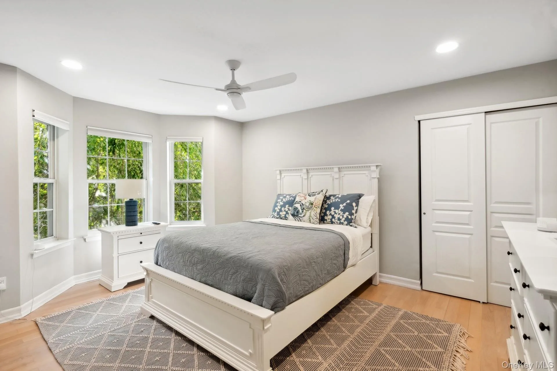 Bedroom with light wood-style floors, recessed lighting, a ceiling fan, and a closet Bedroom with light wood-style floors, recessed lighting, a ceiling fan, and a closet
