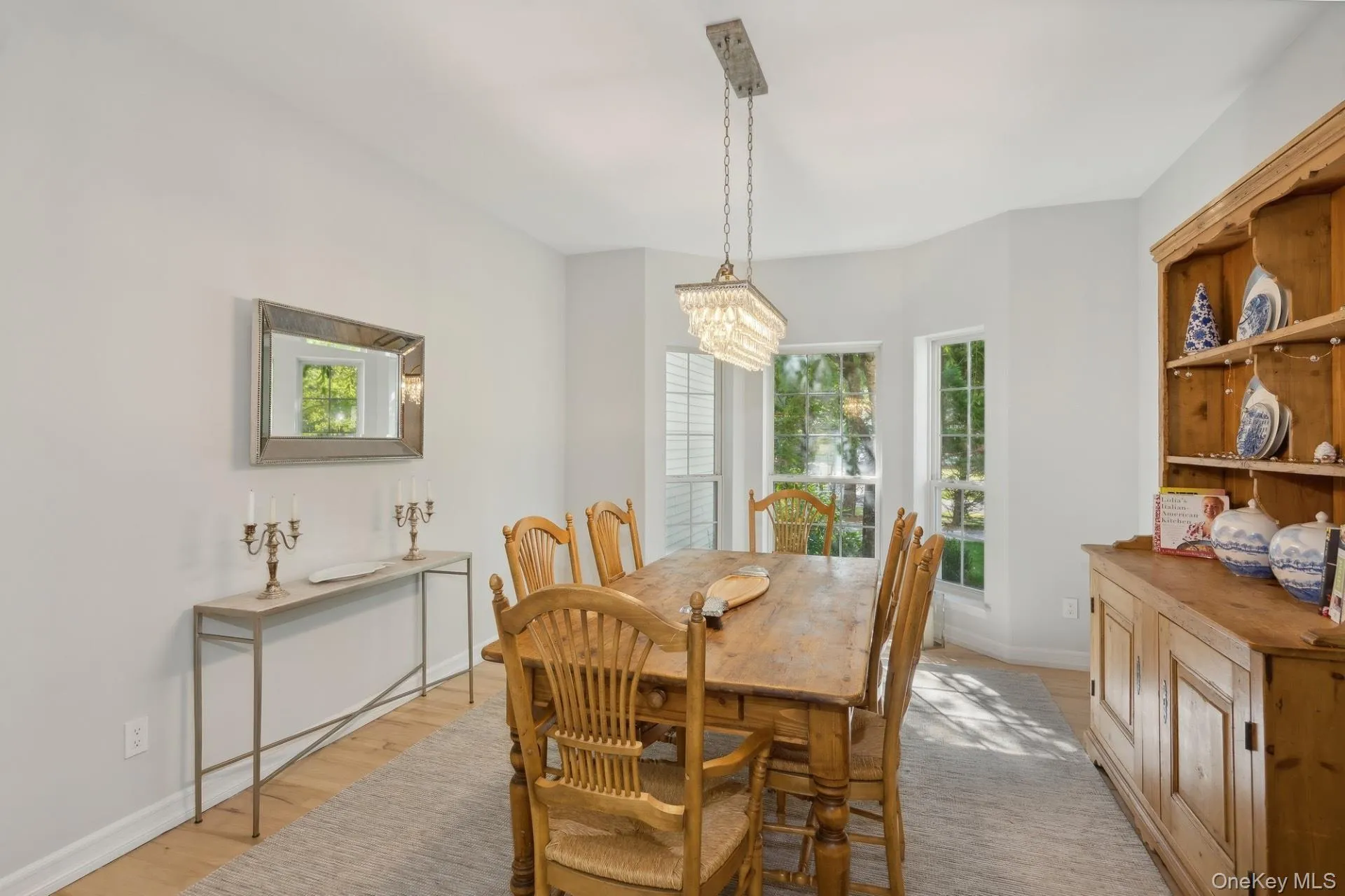 Dining area with light wood finished floors and a chandelier Dining area with light wood finished floors and a chandelier