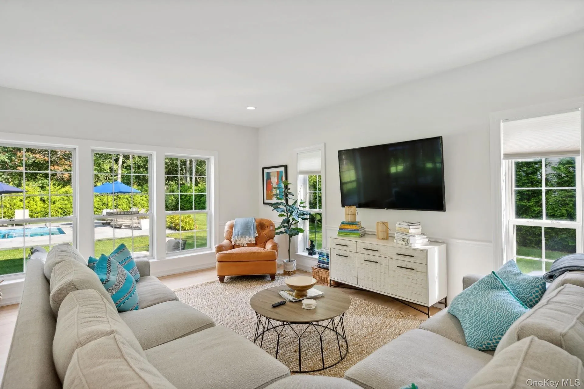 Living area with light wood-type flooring and recessed lighting Living area with light wood-type flooring and recessed lighting