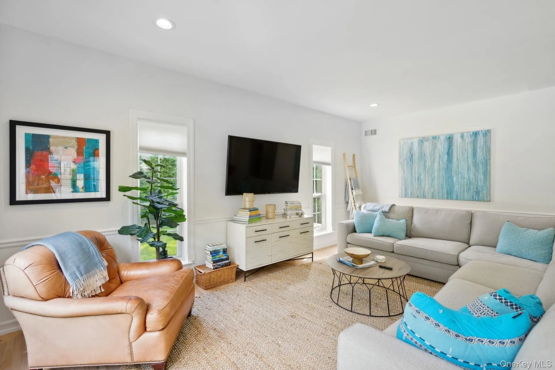 Living area with wood finished floors and recessed lighting Living area with wood finished floors and recessed lighting