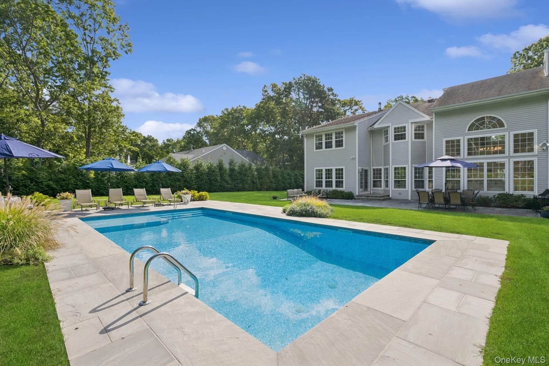 View of swimming pool with a lawn and a patio area View of swimming pool with a lawn and a patio area