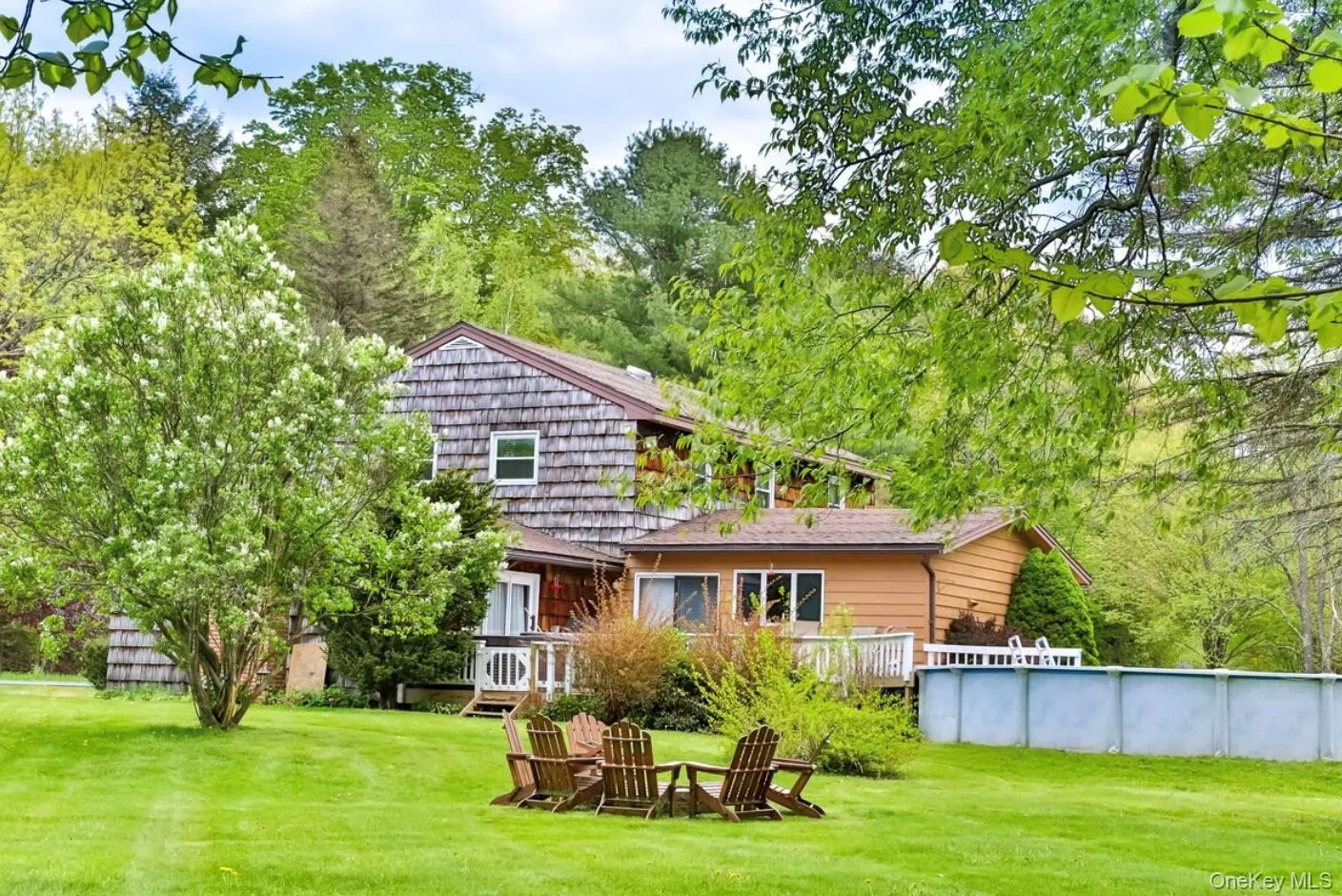 Rear view of property featuring a yard and an outdoor pool Rear view of property featuring a yard and an outdoor pool