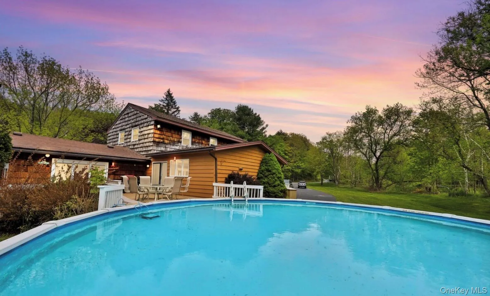 Back of house featuring an outdoor pool, a patio, and a yard Back of house featuring an outdoor pool, a patio, and a yard