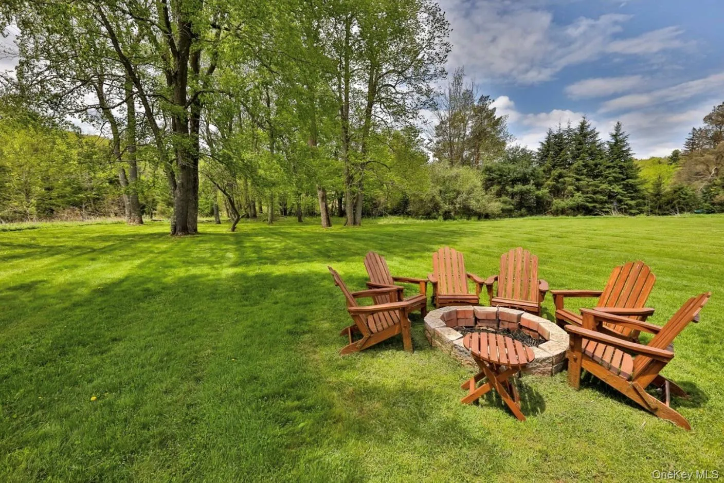 View of grassy yard featuring a fire pit View of grassy yard featuring a fire pit