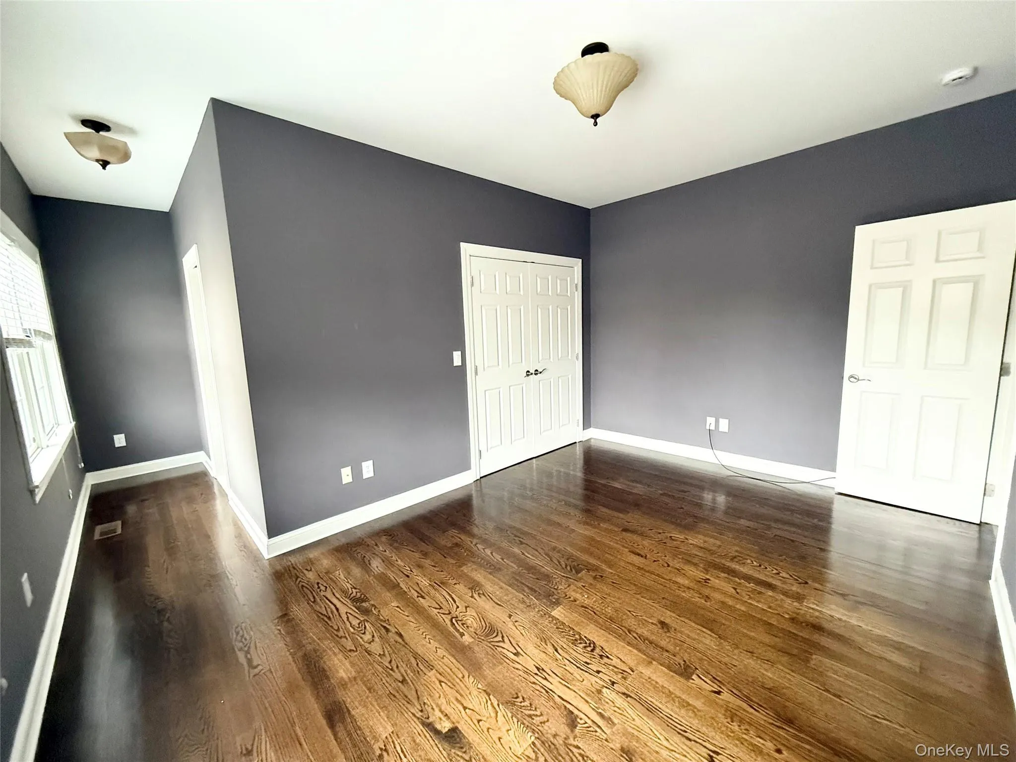 Unfurnished bedroom featuring light colored carpet and a closet Unfurnished bedroom featuring light colored carpet and a closet