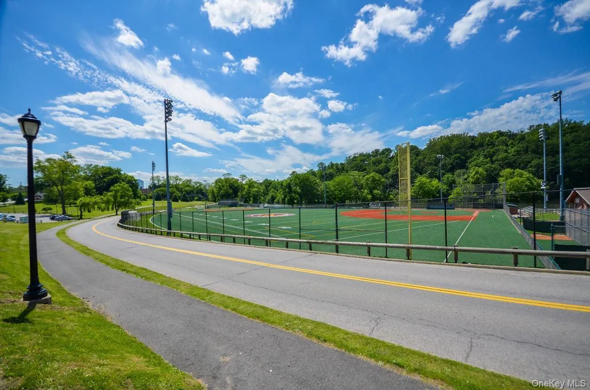 View of asphalt street featuring street lights View of asphalt street featuring street lights