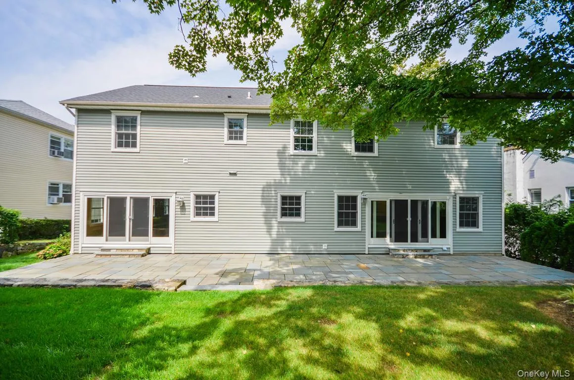 Rear view of property with a patio area and a yard Rear view of property with a patio area and a yard