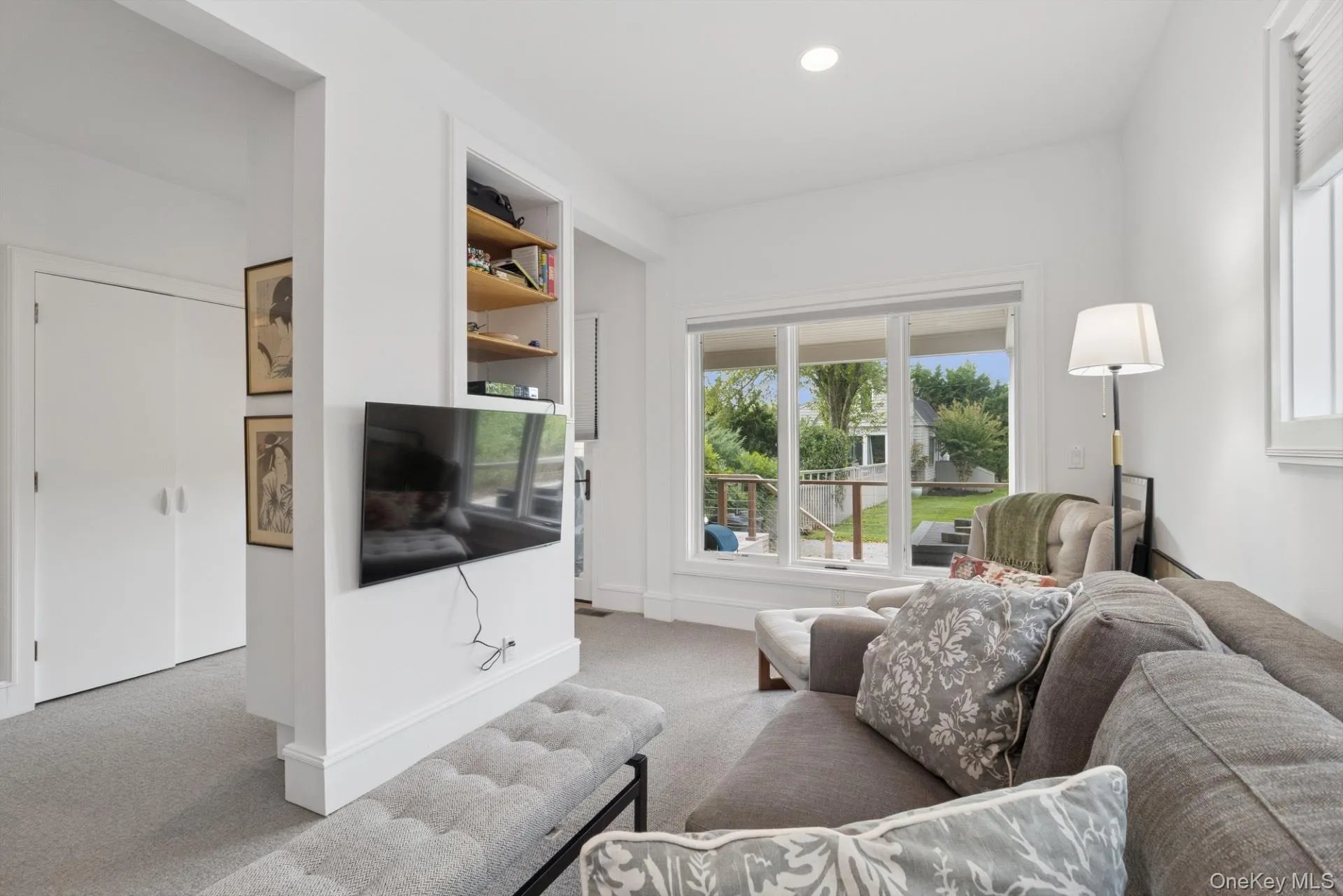 Carpeted living room with baseboards and recessed lighting Carpeted living room with baseboards and recessed lighting