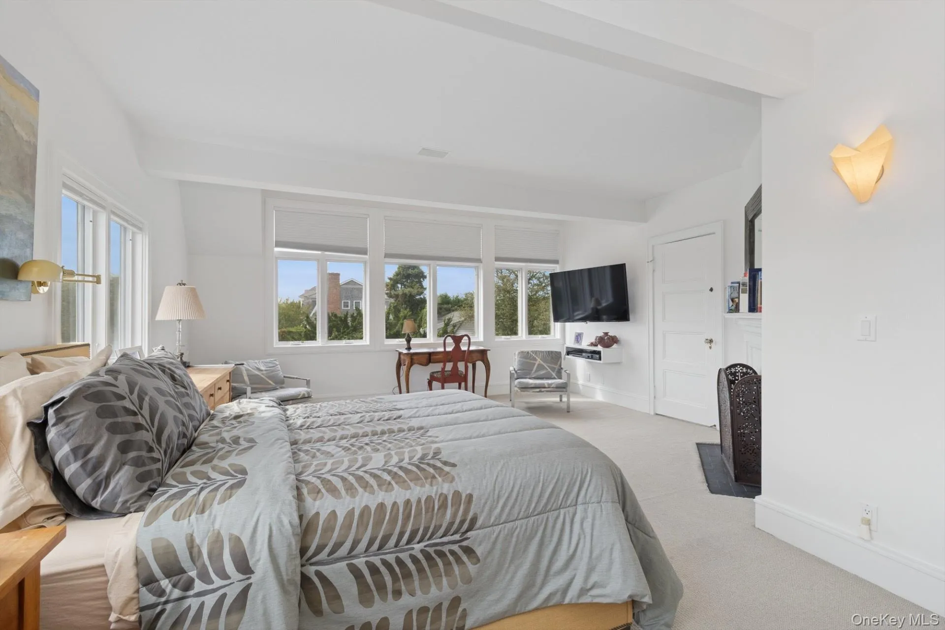 Bedroom with carpet floors and beamed ceiling Bedroom with carpet floors and beamed ceiling