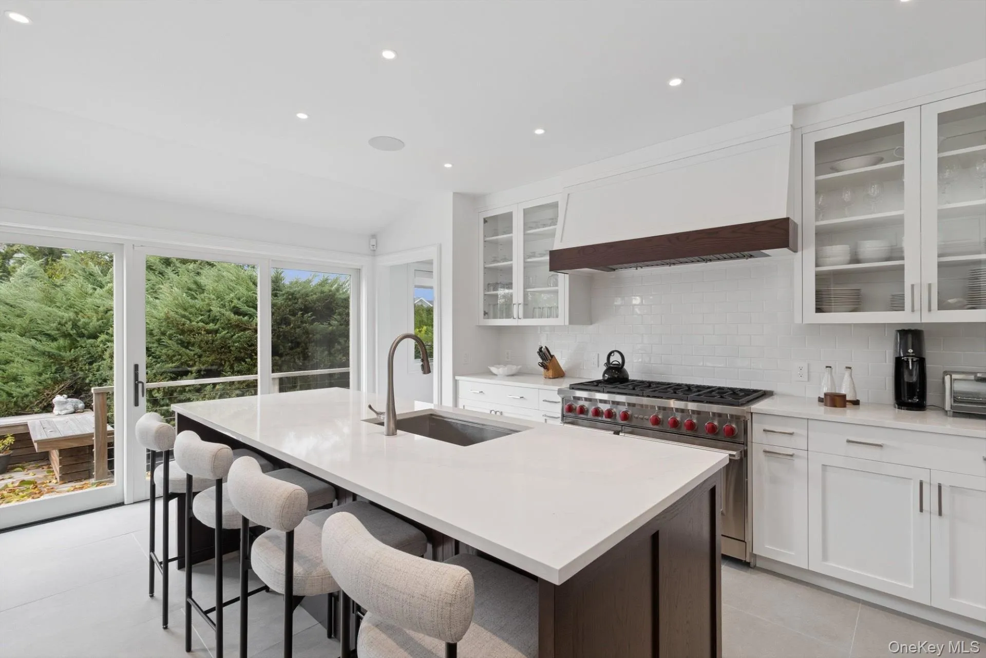 Kitchen featuring recessed lighting, decorative backsplash, white cabinetry, dark brown cabinets, and double oven range Kitchen featuring recessed lighting, decorative backsplash, white cabinetry, dark brown cabinets, and double oven range