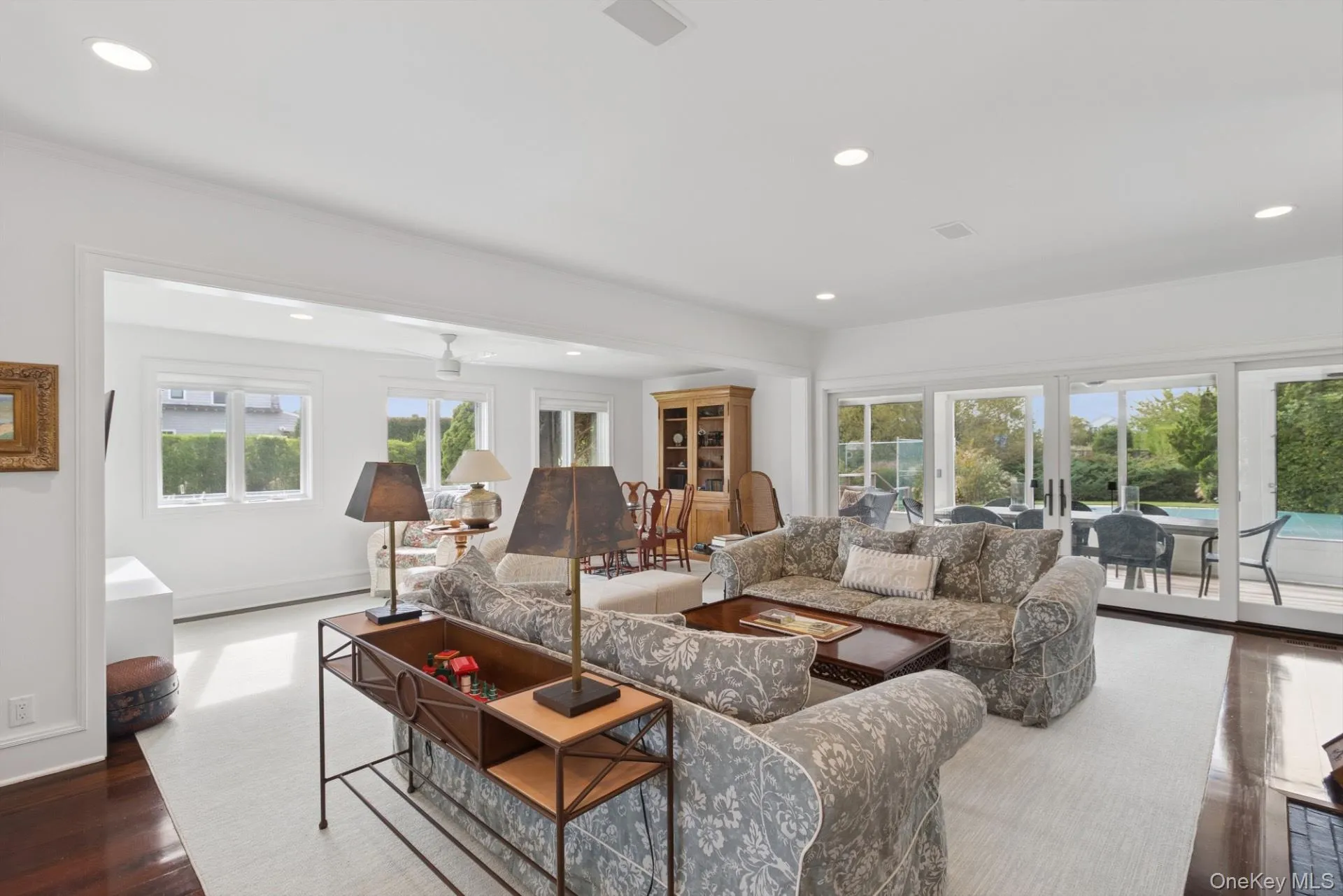 Living room with recessed lighting and dark wood-style floors Living room with recessed lighting and dark wood-style floors