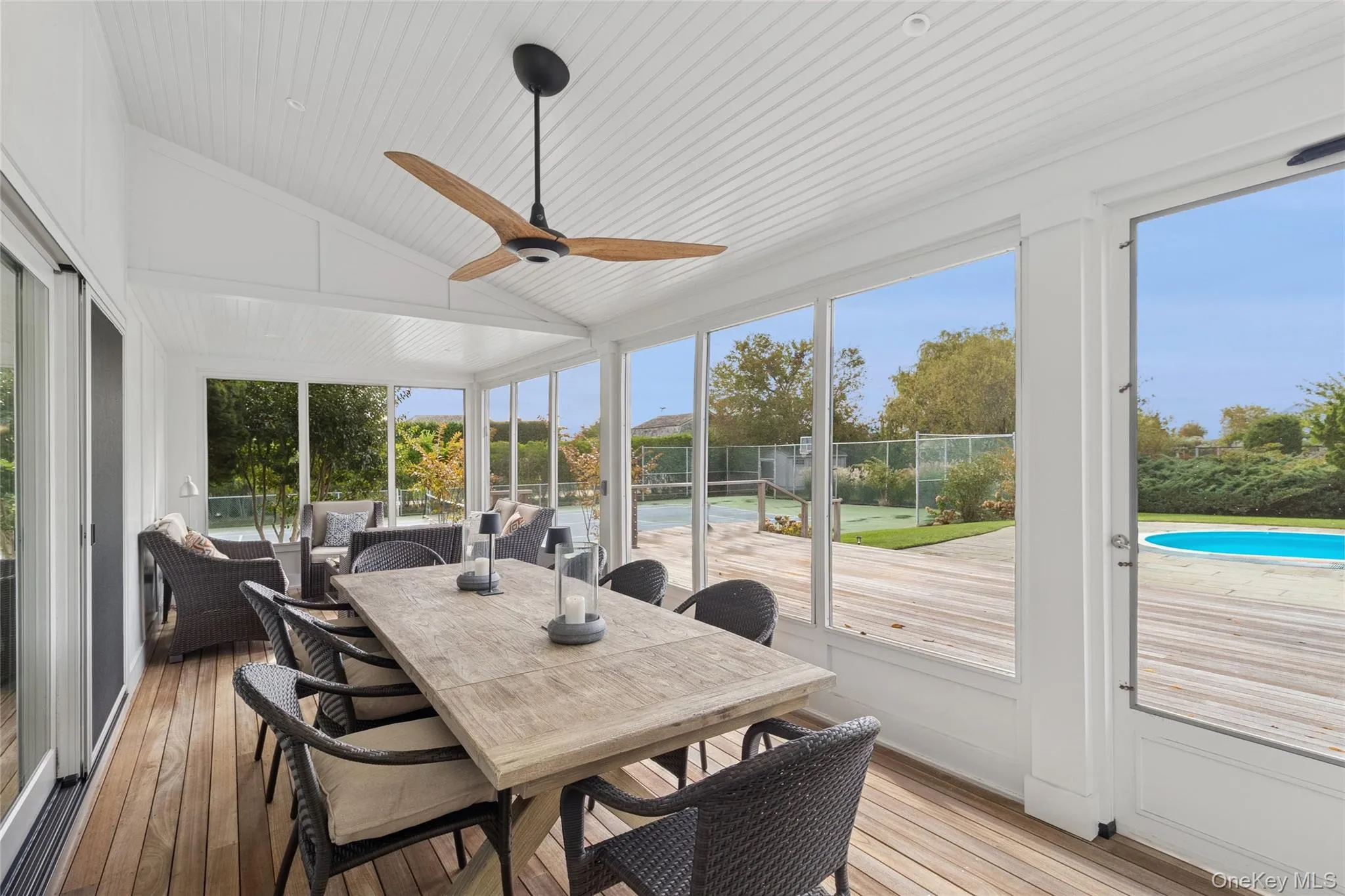 Sunroom / solarium with vaulted ceiling, wood-type flooring, and wooden ceiling Sunroom / solarium with vaulted ceiling, wood-type flooring, and wooden ceiling