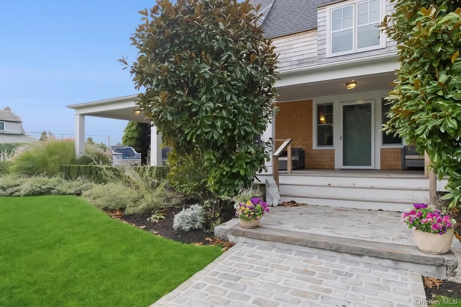 Entrance to property featuring a lawn and a porch Entrance to property featuring a lawn and a porch