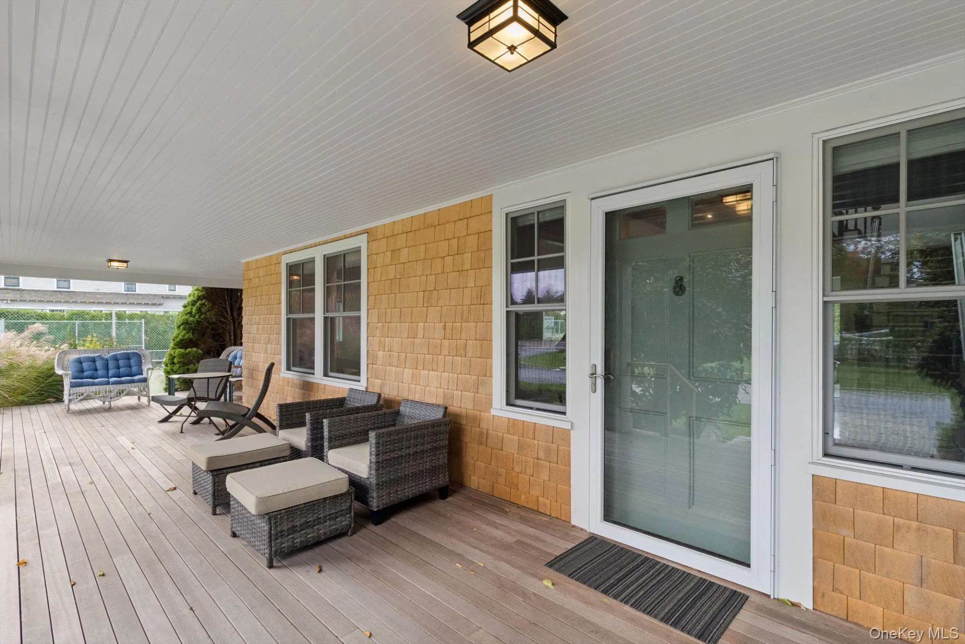 Wooden terrace featuring an outdoor living space Wooden terrace featuring an outdoor living space