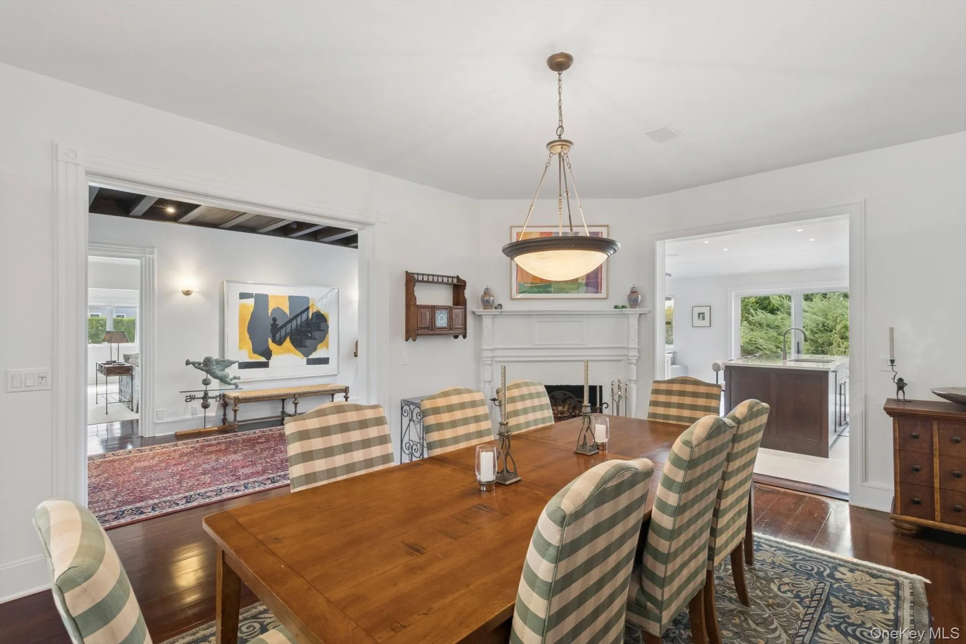 Dining area with dark wood finished floors and a fireplace Dining area with dark wood finished floors and a fireplace